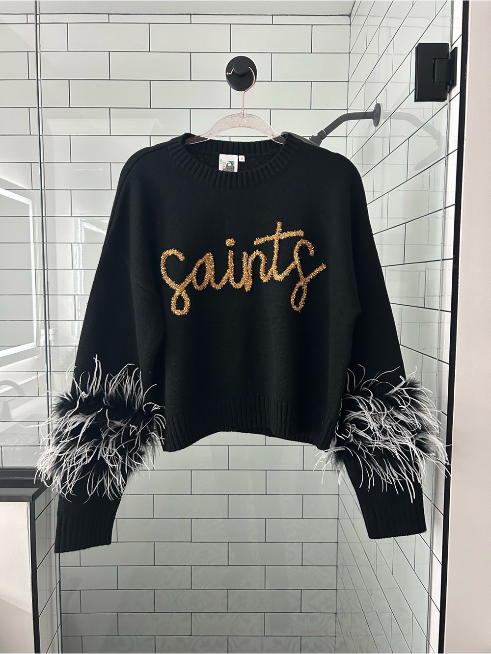 NWOT QOS Black Sweater with Gold Script and Black/White Feather Cuffs